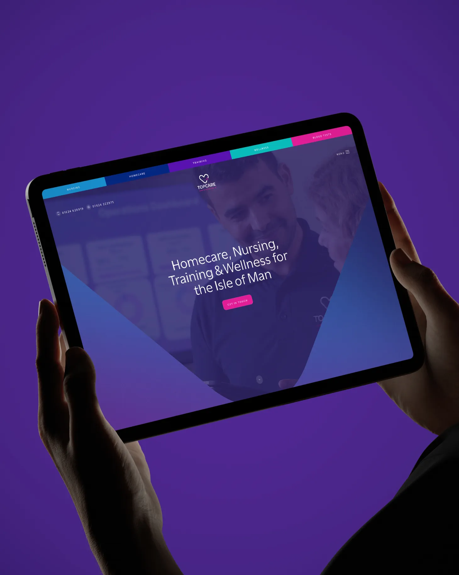 Hand holding a tablet showing the TopCare homecare training and recruitment website